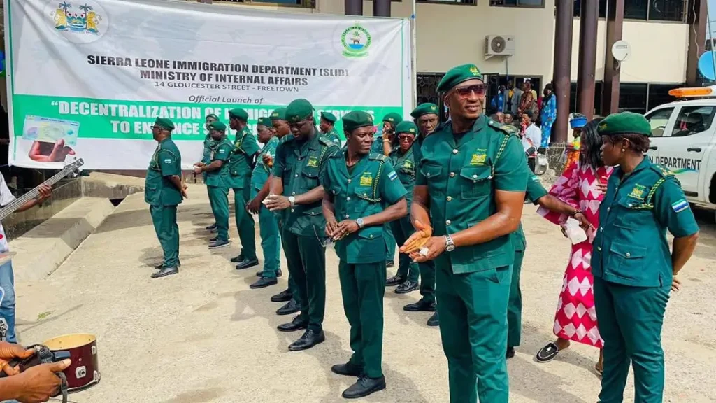 Sierra Leone Immigration Department officers stand during the launch of a decentralization initiative in Freetown as the government intensifies immigration enforcement and inspections targeting foreign nationals without valid work and residence permits.