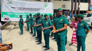 Sierra Leone Immigration Department officers stand during the launch of a decentralization initiative in Freetown as the government intensifies immigration enforcement and inspections targeting foreign nationals without valid work and residence permits.