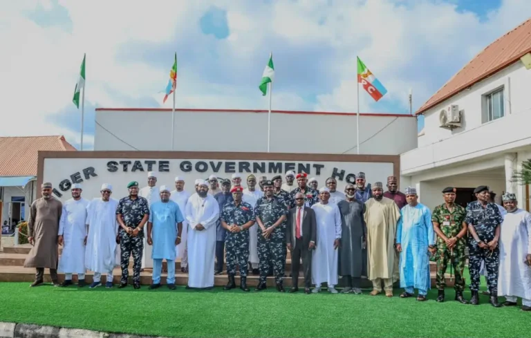 Nigeria’s Inspector-General of Police Olatunji Rilwan Disu poses with government officials, police and security personnel during a condolence visit at the Niger State Government House following the deaths of 37 suspected miners in NSCDC custody.